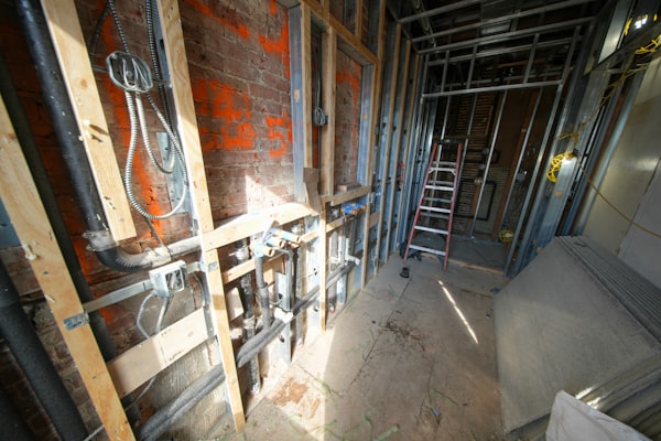 New construction plumbing with exposed pipes and framing